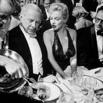 Ambassador Winthrop Aldrich, ex-envoy to Britain chatting with Monroe as her husband, playwright Arthur Miller looks on at April in Paris Ball. Circa 1957.